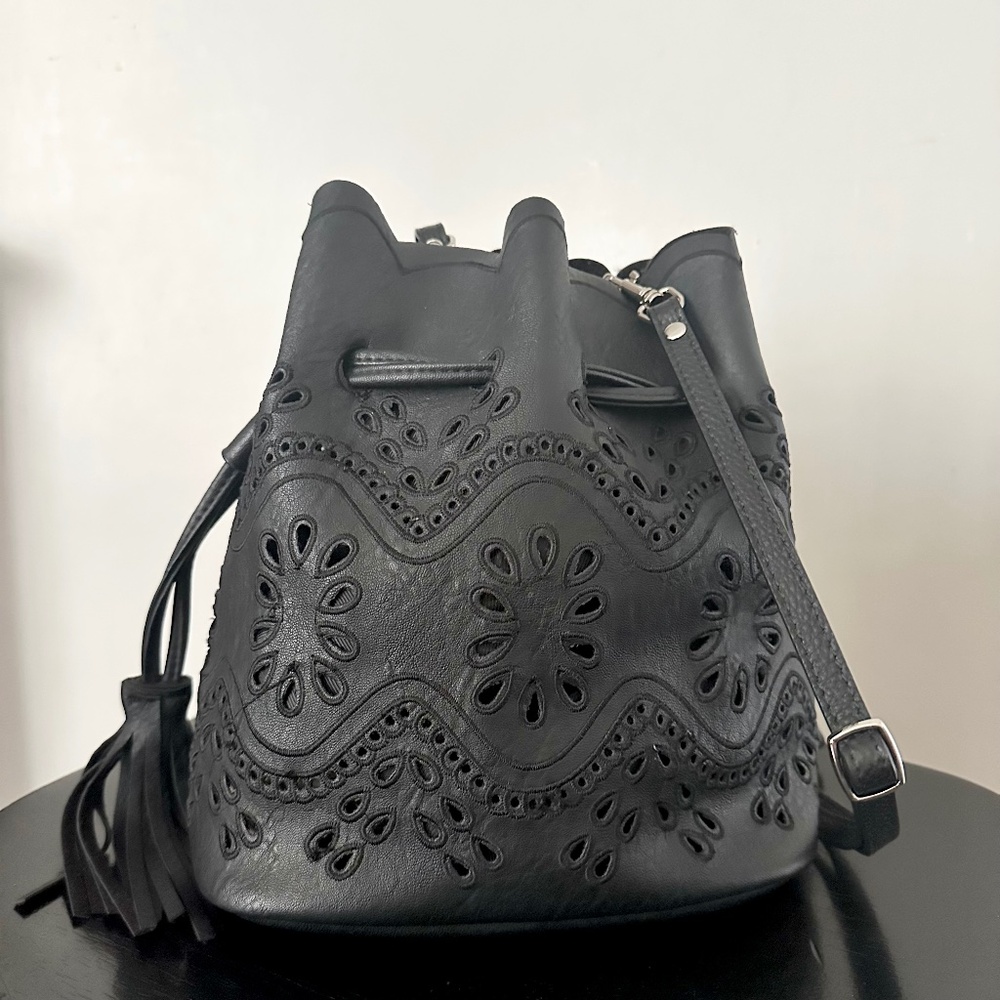 Stencil cut out vegan leather scalloped black bucket bag w/ fringe tassels